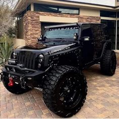 a black jeep parked in front of a house