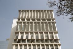 a tall white building with lots of windows