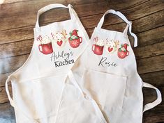 two personalized aprons are sitting on a table