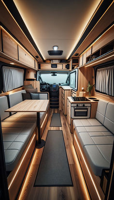 an interior view of a camper with couches and tables in the kitchen area