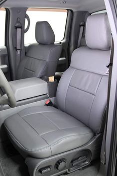 the interior of a vehicle with grey leather seats