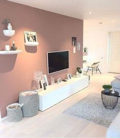 a living room filled with furniture and a flat screen tv on top of a wall