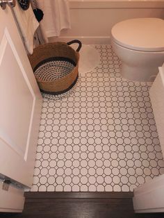 a white toilet sitting next to a bath tub in a bathroom