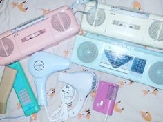 several different types of hair dryers and combs laying on a bed next to each other