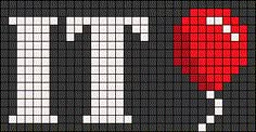 an image of a cross stitch pattern with the letter t in white and red on black