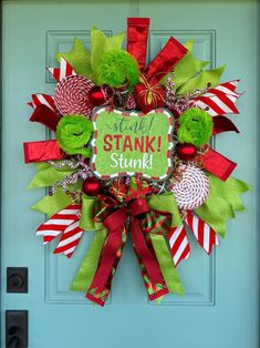 a christmas wreath with candy canes and candies on the front door for st patrick's day