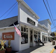 the outside of a building with an american flag hanging from it's roof