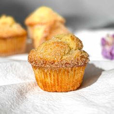 some muffins sitting on top of a white napkin