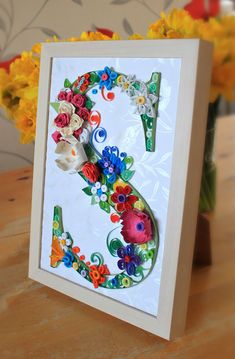 a card with the number five decorated with flowers