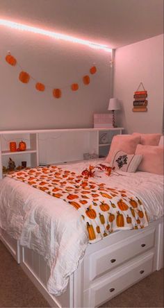 a white bed topped with lots of pillows next to a night stand and book shelf