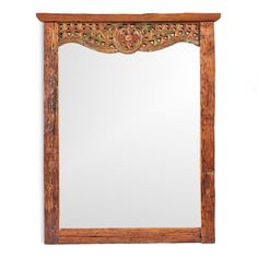 a wooden mirror hanging on the wall with an ornate frame and wood trimmings