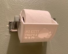 a white toilet paper holder with no kitty that's a bad sign on it