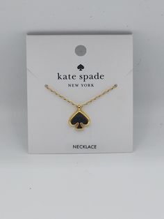 This Kate Spade necklace features a black enamel spade pendant with a gold-tone finish. The pendant is attached to a cable chain with an adjustable lobster closure, making it suitable for all occasions. The necklace is handmade and has a unique charm pendant shape. The pendant has a spade shape and is eye-clean, with no stone treatments. The necklace has a main stone shape of spade and is not antique or vintage. It is a beauty theme and was manufactured in China. The necklace comes with a package that includes the necklace length, but this is not specified in the product. Spade Necklace, Kate Spade Necklace, Gold Charm Necklace, Gold Tone Necklace, Fashion Jewelry Necklaces, Unique Charms, Black Enamel, Necklace Length, Cable Chain