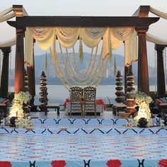 an outdoor wedding setup with chairs and flowers