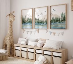 there are three pictures hanging on the wall in this room, and one has a giraffe