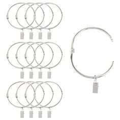 six pairs of silver colored metal bracelets with tags on each side and four different sized clasps