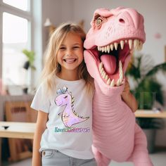 "Super Cute Personalized Purple T-Rex Girl Dinosaur T-Shirt for Kids, Toddler, Baby and Adults! Customized with or without Her Name+SAURUS, Rex, Etc Examples: Mayasaurus, Eviesaurus, Sophia-Rex, Birthday Girl, Kindergarten Graduate, etc Pretty Girl Dinosaur T-shirt Printed for Each Customer on a Super Soft, Premium Ring-spun Cotton Tee, printed using Vegan, Eco-Safe Inks Makes a GREAT Birthday Girl gift and makes her birthday or school day much more memorable! FAST Add-On Upgrade Option for a Ta Birthday Toddler Girl, Dinosaur Name, Girl Dinosaur, Cheap Vinyl, Girls T Shirts, Dinosaur Shirt, Matching Cards, Cute Dinosaur, Dinosaur Birthday