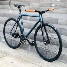 a blue bike parked on the side of some steps