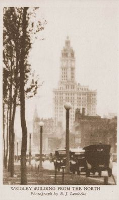 an old black and white photo of a city with tall buildings in the background,