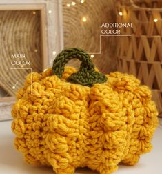 a crocheted pumpkin sitting on top of a table