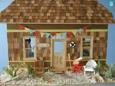 a doll house with furniture and decorations on the front porch is shown in this image