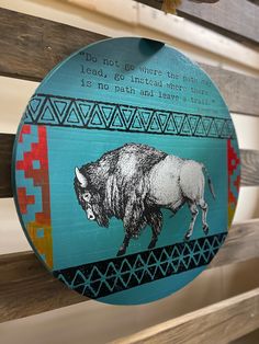 a wooden sign with an image of a buffalo on it