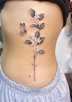 a woman's stomach with flowers and butterflies on it