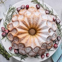 a cake with powdered sugar and cranberries on top