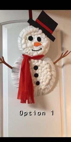 a snowman made out of yarn is hanging on the front door and says, option 1