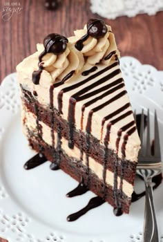 a piece of cake with chocolate and peanut butter on top sitting on a white plate