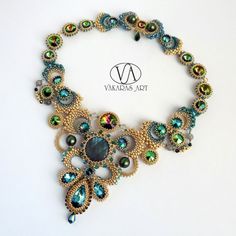 the necklace is adorned with green and blue beads