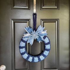 a blue and white wreath hanging on the front door