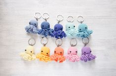 small crocheted octopus keychains in different colors on a white table top