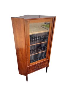 an old fashioned wooden cabinet with glass doors