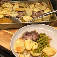 two pans filled with food sitting on top of a wooden counter next to each other