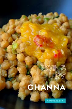 a black plate topped with chick peas and cheese next to the words boil & fry channa