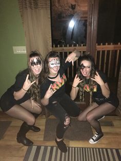 three girls with painted faces posing for the camera