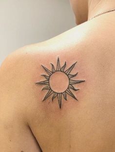 a woman with a sun tattoo on her back