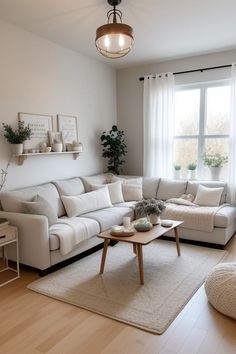 a living room filled with furniture and a white rug on top of a hard wood floor