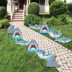 shark shaped lawn decorations in front of a house