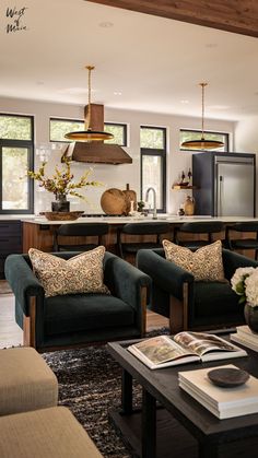 a living room filled with furniture next to a kitchen