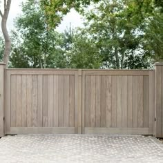 a wooden fence with an open gate in the middle