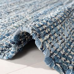 a blue and white rug on the floor with an open hole in it's center