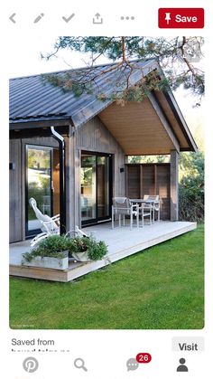 a small wooden house sitting on top of a lush green field