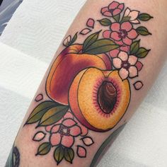 a peach and flower tattoo on the arm