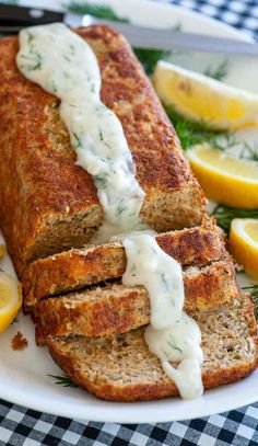 a plate with some bread on it and lemon wedges around the edge next to it