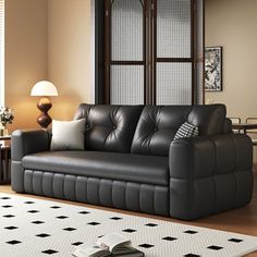 a living room with a black leather couch and white rug in front of the window