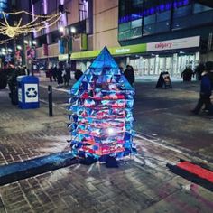 a blue christmas tree is on the street