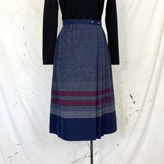 "Navy striped wrap skirt with pleated front and button waistband closure. No contents tag other than Dry Clean Only, presumed pure wool.  Best fits: S Measurements:  Waist: 25.5,\" Hips: 37,\" Length: 28.5\" Condition:  Very good vintage condition Shop notes: All vintage items have a past, as such they may have minor imperfections. I do my best to mend anything major and call out what cannot be fixed.  All garment measurements are taken flat.  I ship in reusable, sustainable packaging in an effort to be more environmentally friendly.  Thank you for supporting my small business and I'm happy to answer any questions you may have!  All sales final." Elegant Cotton Wrap Skirt, Vintage Wrap Skirt, Relaxed Knee-length Cotton Wrap Skirt, Relaxed Cotton Knee-length Wrap Skirt, 90s Wrap Skirt, Vintage Wrap Dress, Work Outfits Frauen, Plaid Trousers, Corduroy Skirt