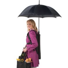 a woman in a pink coat is holding an umbrella